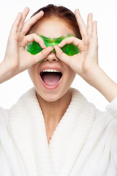 cheerful woman in a white robe facial care rejuvenation lifting. High quality photo