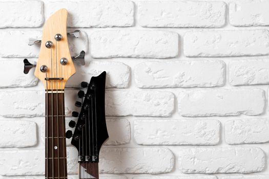 Guitar headstock with tuners on dark background close up