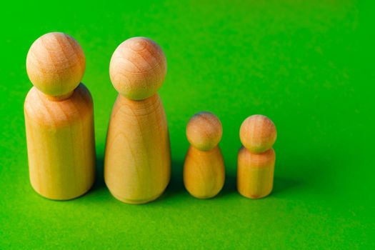 Small wooden figures of family members close up. Family relationship symbol