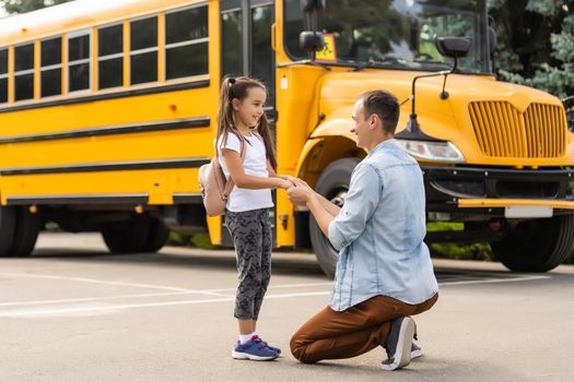 Happy day of back to school. Smiling father taking child to primary school.