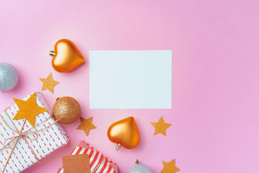 Christmas festive decorations with copy space on pink background, top view