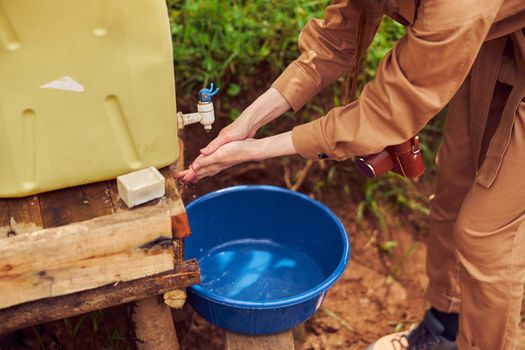 woman tourist is washing her hands while travelling in african region