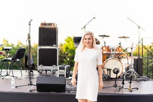 an empty concert hall, woman near empty chairs at concert