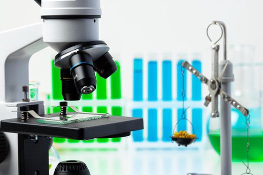 Medical laboratory. Scientific microscope with test tubes and plants for research
