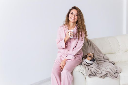 Glamorous girl with happy smile in good morning. Positive female model drinking hot tea.