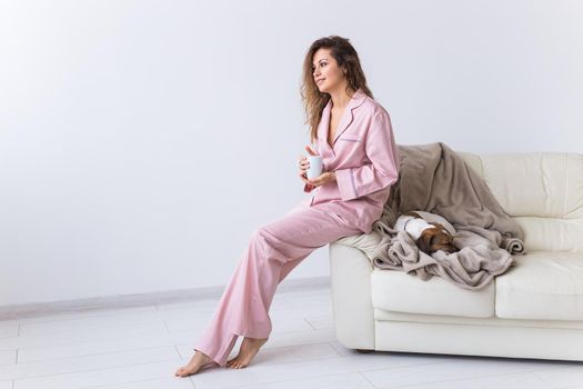 Glamorous girl with happy smile in good morning. Positive female model drinking hot tea.