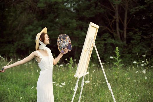 cheerful woman outdoors drawing art landscape hobby. High quality photo