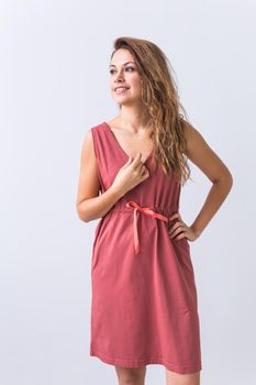 beautiful blond fashion model in blue dress and coral lips on white background.