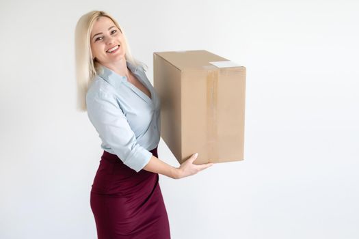 A young beautiful caucasian woman holding a box in her hands.