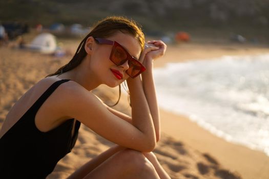 woman in a black swimsuit on the beach sea Summer vacation. High quality photo