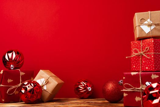 Wrapped christmas gift boxes against red background front view