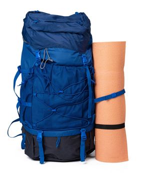 Blue hiking backpack with fitness mat isolated on white background