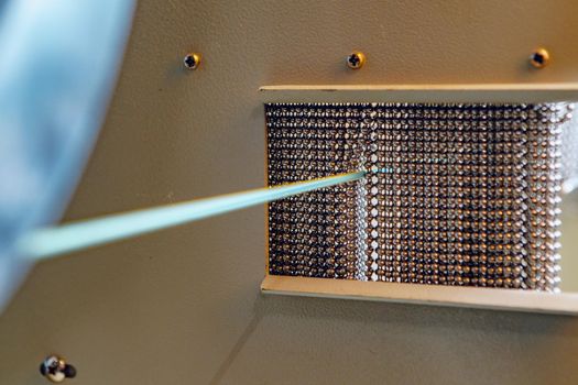 Inside a modern plant producing power electric cables and optical fibers. .Cable manufacturing machine part. Close up.
