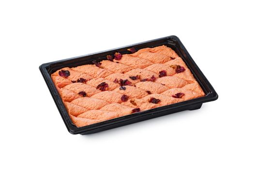Black plastic box of Turkish halva dessert isolated on white background