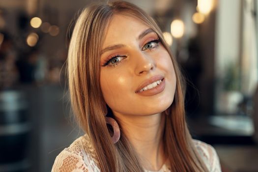 Beautiful female model portrait in a cafe. Close up.