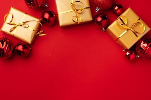 Red Christmas baubles on red background top view, copy space