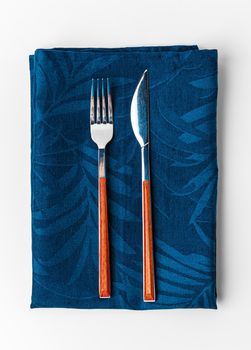 Set of fork and knife on towel. Isolated on white background. Close up.