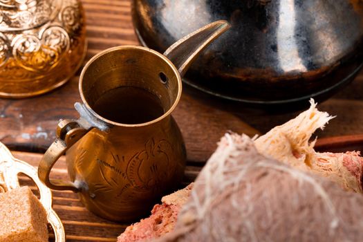 Turkish metal tableware on dark wooden table close up