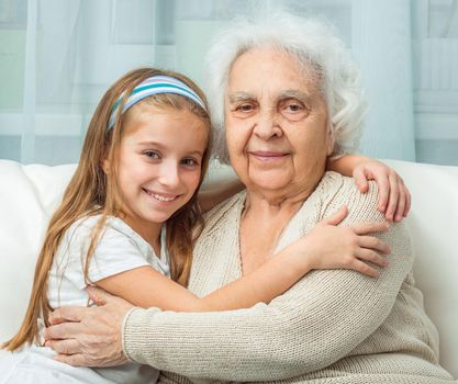 portrait of grandmother and granddaughter embracing