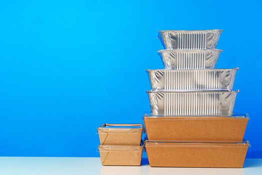 Assortment of various food delivery containers on table close up