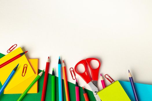 Top view of school supplies, pencils and notepad, copy space