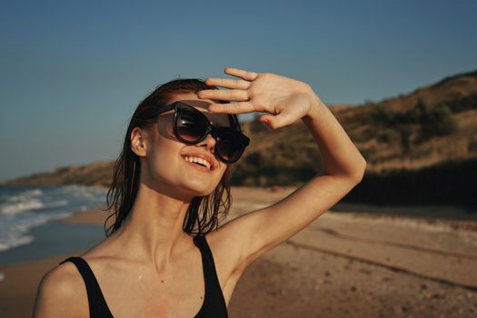 woman on the beach in sunglasses in a swimsuit sun. High quality photo
