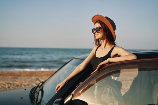 woman on the beach near car travel adventure summer. High quality photo