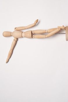 wooden mannequin posing on light background toy object. High quality photo