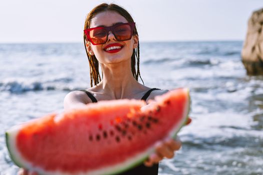 cheerful pretty woman in black swimsuit watermelon fashion travel. High quality photo