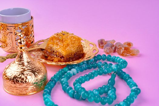Cup of coffee and turkish dessert baklava on pink background