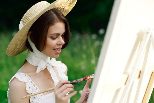 woman artist paints a picture outdoors easel creative. High quality photo