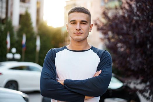 Portrait of handsome young casual man walking on the city street