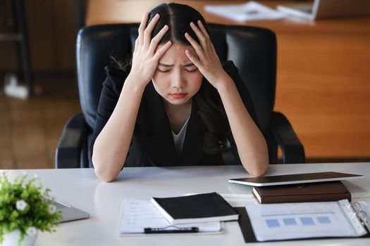 Company employees show boredom from unfinished work using computer notebook, documents and tablets at work