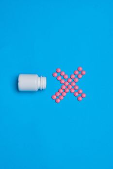multicolored pills treatment health care blue background. High quality photo