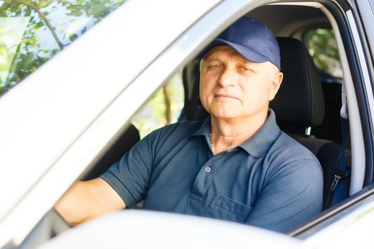 Elderly man driving a car