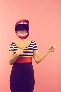 Stylish fashion sexy bad crazy girl with an open mouth instead of a head. Red lips .Pointing a side. Pink background