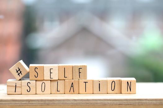 Wooden cubes with the word Self isolation and a question mark for Covid-19, coronavirus needs quarantine concept. virus