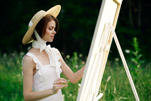 Woman in white dress artist hobby nature landscape. High quality photo