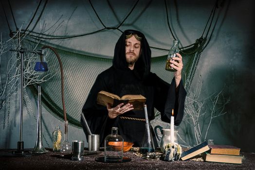 The medieval scientist medieval scientist in his lab reads a spell. Halloween