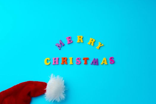 Words Merry Christmas on blue background top view, copy space