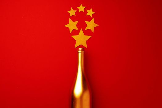 Festive background with champagne bottle and confetti top view