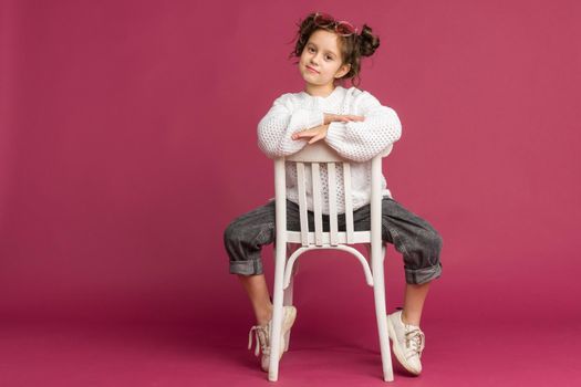 Photo of smiling little girl child isolated over pink background. Looking camera.