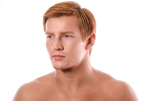 Handsome young man portrait isolated on white background. Muscular teenage guy portrait. Teenager boy face closeup