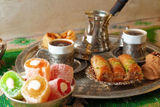 Turkish Coffee served with Turkish Delight on metal tray, close up