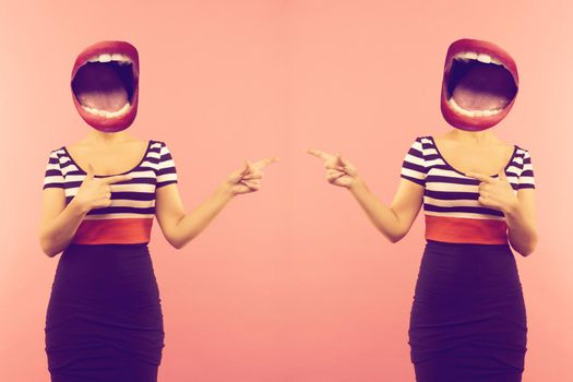 Stylish fashion sexy bad crazy girl with an open mouth instead of a head. Red lips .Two woman pointing a side. Pink background