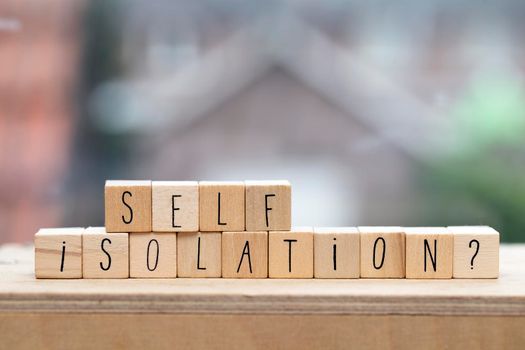 Wooden cubes with the word Self isolation and a question mark for Covid-19, coronavirus needs quarantine concept. virus