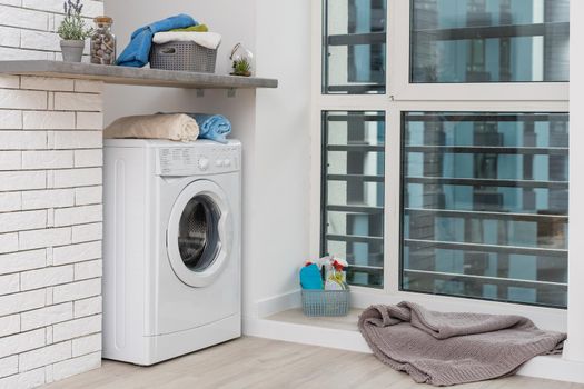 Contemporary luxury laundry in a brand new apartment in white.