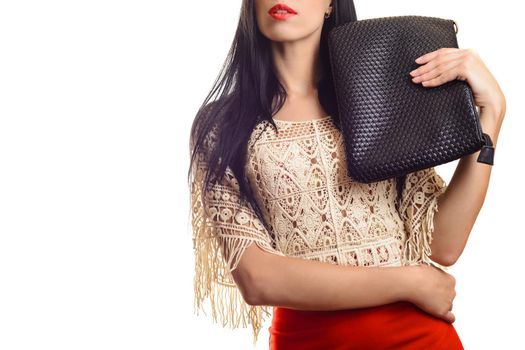 Trendy young girl in red skirt holding black leather handbag white background