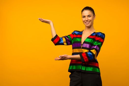 Young lesbian girl and an LGBT community representative posing in a flag coloring jacket LGBTQ shows something - image