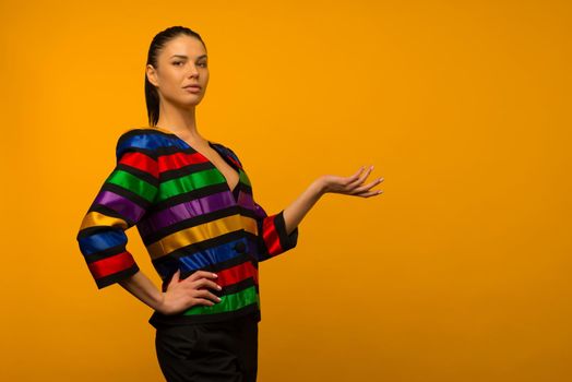 Young lesbian girl and an LGBT community representative posing in a flag coloring jacket LGBTQ shows something - image